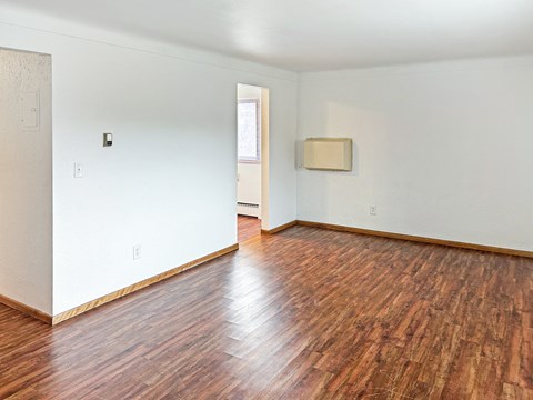 A room with wooden floors and white walls.